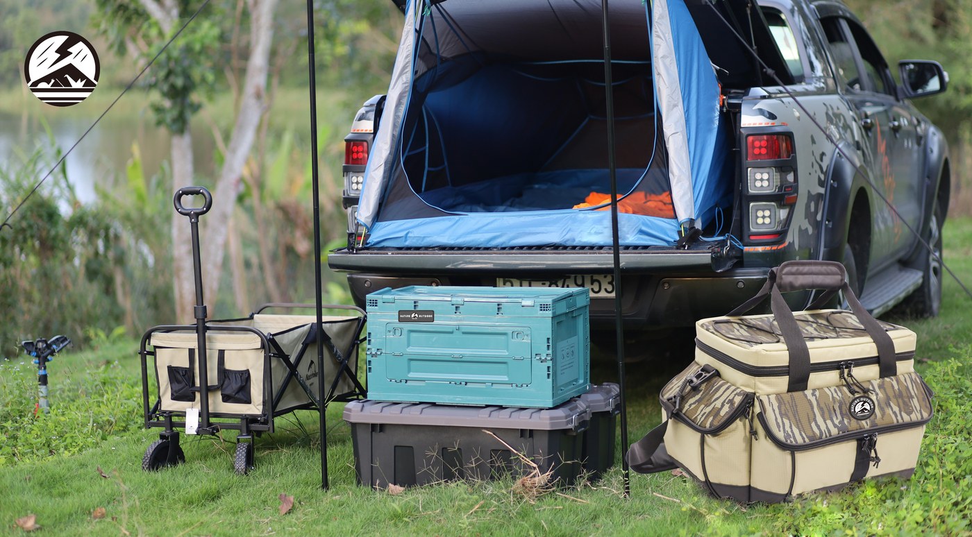 Camping tents and outdoor cooler bags in a campsite